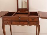 a small wooden table with a mirror on top of it