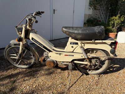 un cyclomoteur garé devant un garage