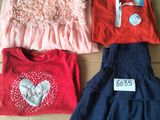 three children ' s clothes are on a cardboard box with a price tag