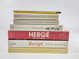 four books stacked on top of each other on a white surface