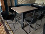 tables and chairs in a restaurant with a tiled floor and wallpaper