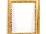 a gold frame on a white wall with a white background