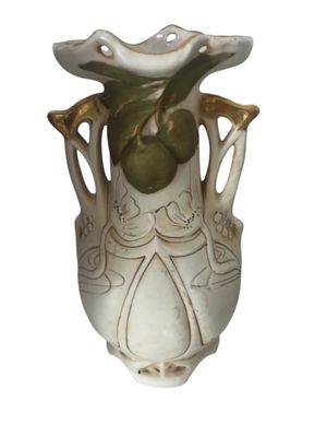 un vase blanc orné d'une feuille verte