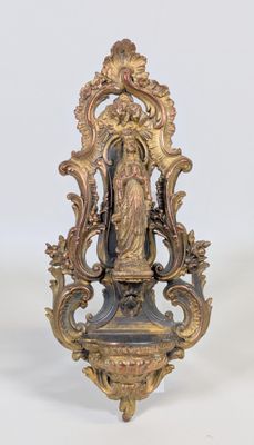 a statue of a woman on a stand on a white surface