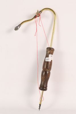 a small wooden object with a red string attached to it