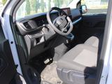 the interior of a white truck with the driver ' s seat down