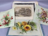 four cards with flowers on them sitting on a table