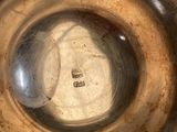 a close up view of a metal bowl with a hole in it