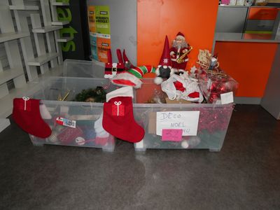 many christmas decorations in the bins on the floor