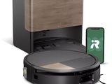 une image d'un aspirateur robotisé avec un téléphone à côté