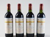 three bottles of wine are lined up on a white surface