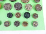 many different types of buttons on a green surface