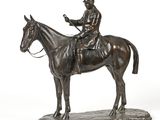 bronze statue of a man on a horse on a white background