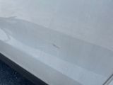 a white car that has a dent in the side of it