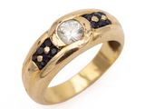 a close up of a gold ring with a white diamond and blue sapphires