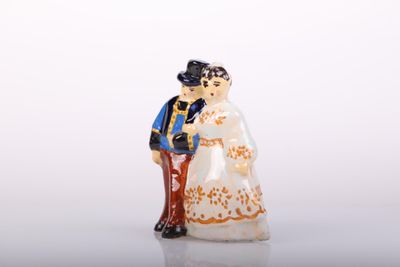 a figurine of a man and a woman standing next to each other