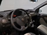 dashboard of a small car with a steering wheel and a dash light