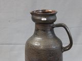 a brown vase that is sitting on a table