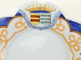 a plate with a crest on it and a crown on it