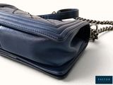 an image of a blue purse with a chain on it