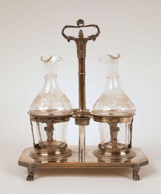 an image of a silver plate with two glass vases on top of it