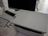 a desk with a computer and a printer on it