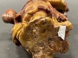a close up of a figurine of a turtle on a table