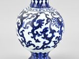 blue and white vase with a dragon design on the outside