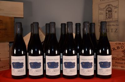 six bottles of red wine are lined up on a table