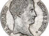 gros plan d'une pièce de monnaie sur laquelle figure un visage de femme