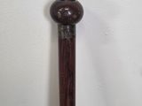 a close up of a cane with a wooden handle