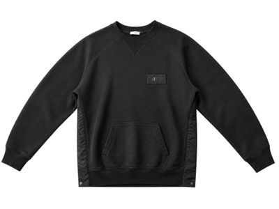 a picture of a black sweatshirt with a small patch on the chest