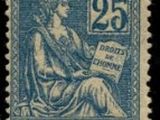 a stamp with a woman sitting on top of a chair