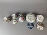 many different types of tea cups and saucers on the table