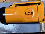 a yellow machine that is sitting on top of a box