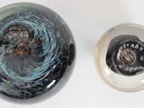 a black and white object with a blue swirl on it