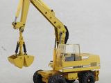 a yellow toy truck with a large excavator on it ' s back