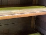 a wooden shelf with a green shelf underneath it