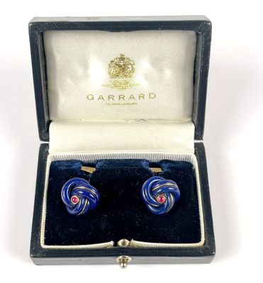 pair of blue glass earrings in a box with a key