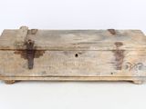 an old wooden box that is sitting on a table