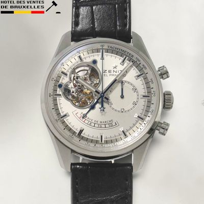 a close up of a watch with a black leather strap