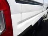a white van parked in a parking lot next to a building
