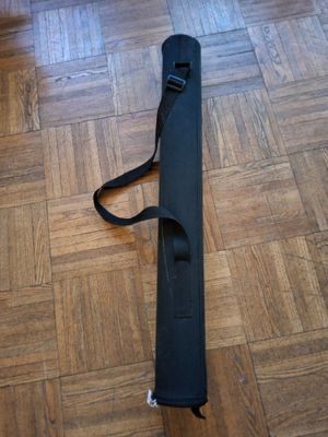 a black case sitting on the floor with a strap around it