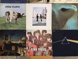 a lot of pink floyd posters on the wall