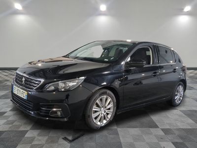 the black car is parked on a checkered tile floor