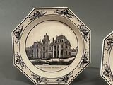 two plates that have a picture of a building on them
