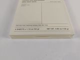 a stack of white papers sitting on a white surface