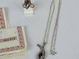 a necklace, ring, and ring on a table