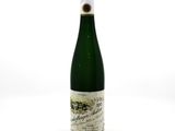 a bottle of wine sitting on top of a white table