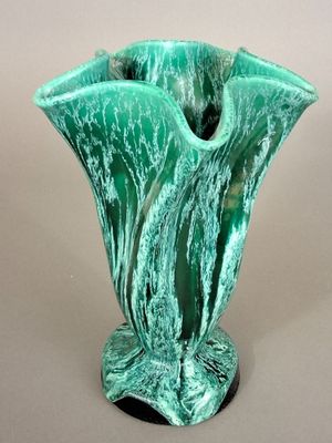 a green vase that is sitting on a table